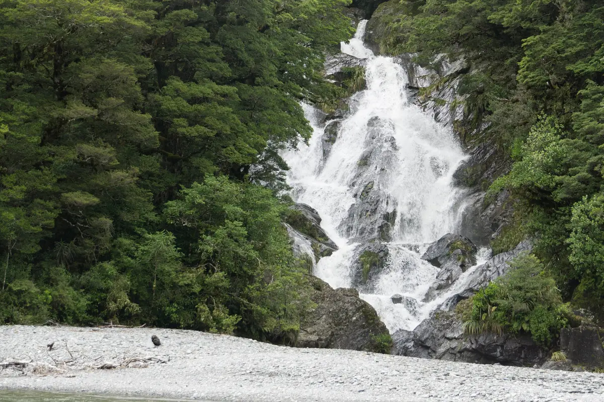 Fantail Falls spilling over rock onto a gravel bed